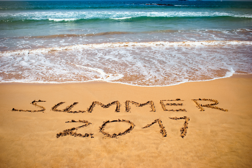 Inscription on wet sand Summer 2017. Concept photo of summer vacation on the tropical island ocean beach.